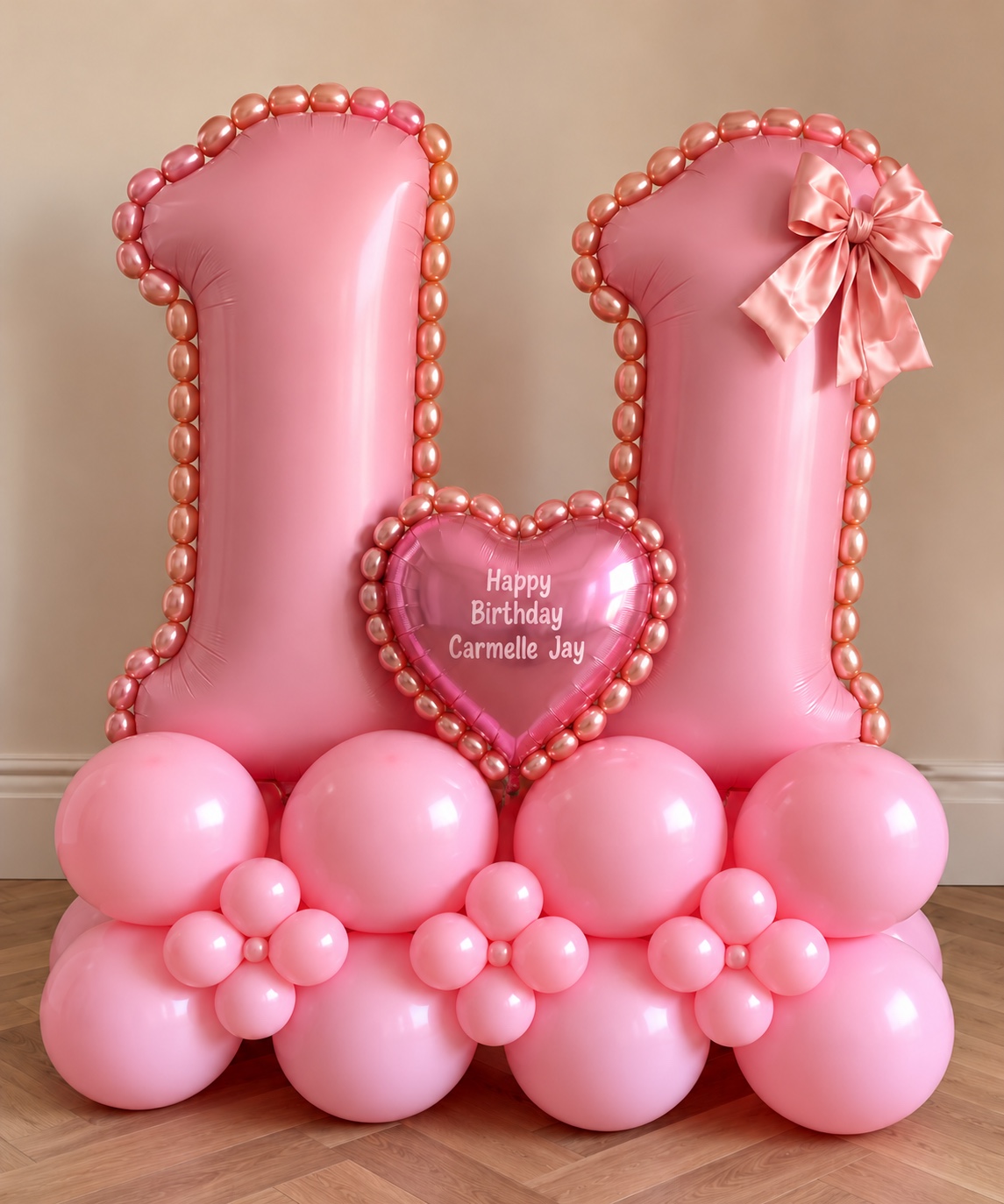 Pink number 11 birthday balloon display with a personalised heart, bow and balloon flowers